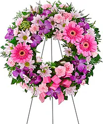 Corona funebre di gerbere e/o margherite, garofani e fiori misti dai toni accesi