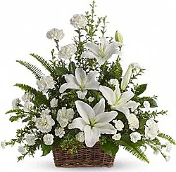 Composizione funebre di gigli o lilium, garofani e fiori misti dai toni chiari. Per le occasioni di condoglianze, lutto, funerale.